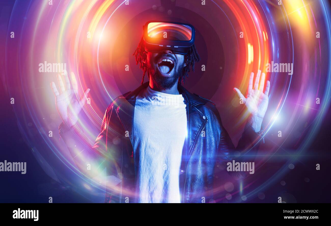 Man with VR glasses play with a virtual videogame Stock Photo