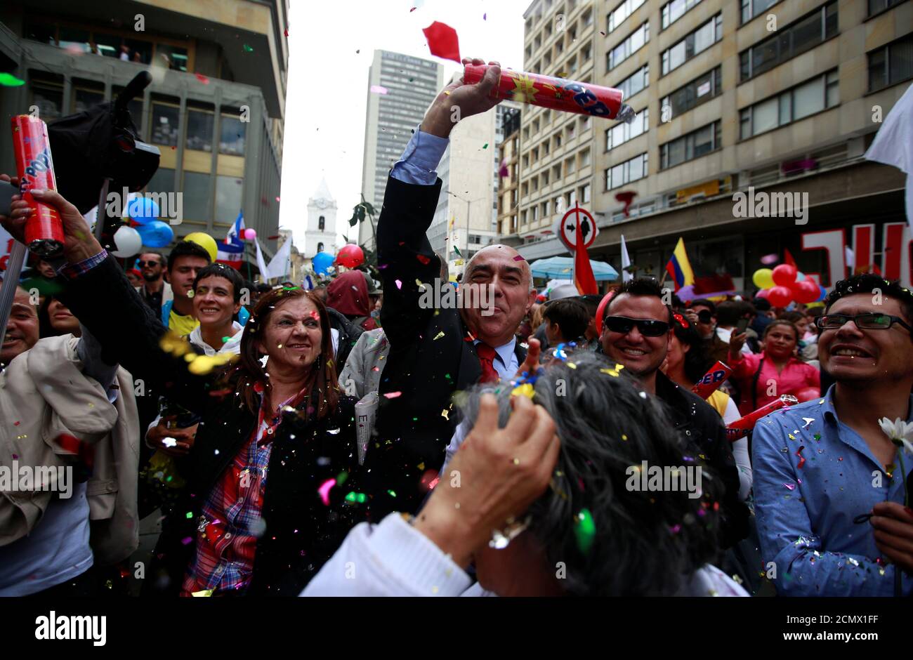 People celebrate the signature of a historic ceasefire deal between the Colombian government and FARC rebels, in Bogota, Colombia, June 23, 2016. REUTERS/John Vizcaino Stock Photo