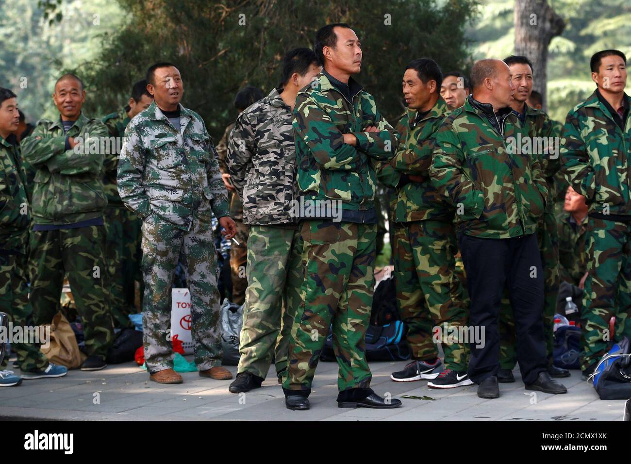 Uniformed people take part in a protest outside the Bayi Building, a major Chinese military building in Beijing, China, October 11, 2016.  REUTERS/Thomas Peter Stock Photo
