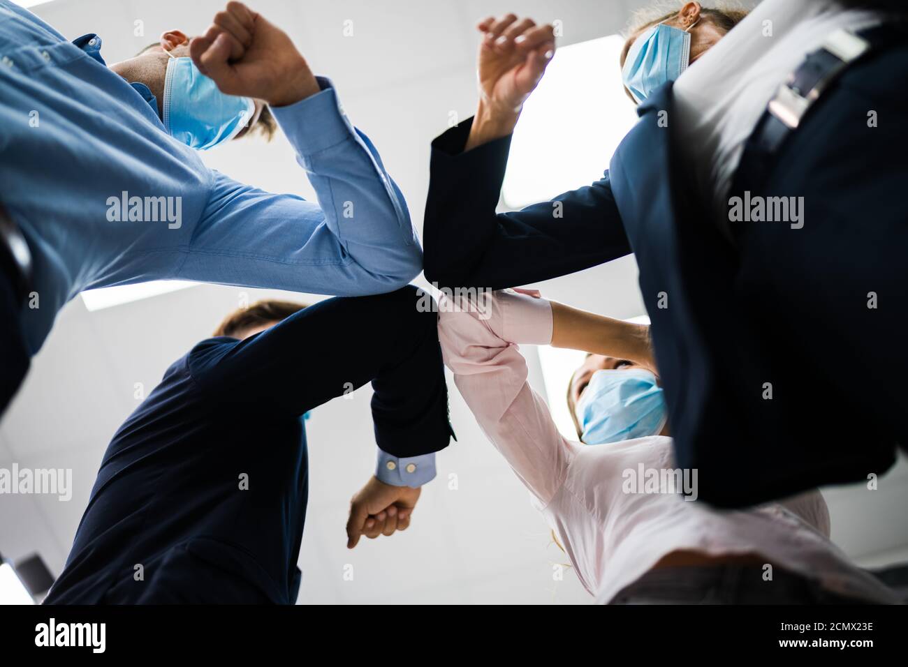 Employees Doing Elbow Bump To Avoid Flu And Stop Covid Spread Stock Photo