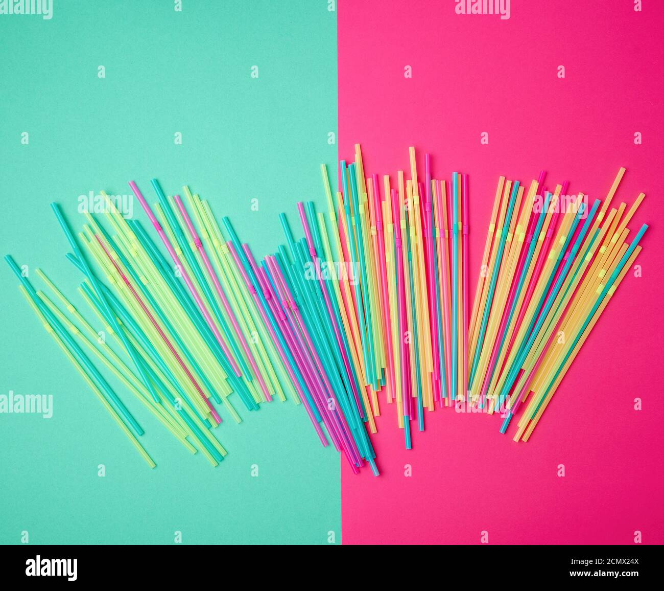 stack of multi-colored plastic tubes for a cocktail on a multi-colored background Stock Photo