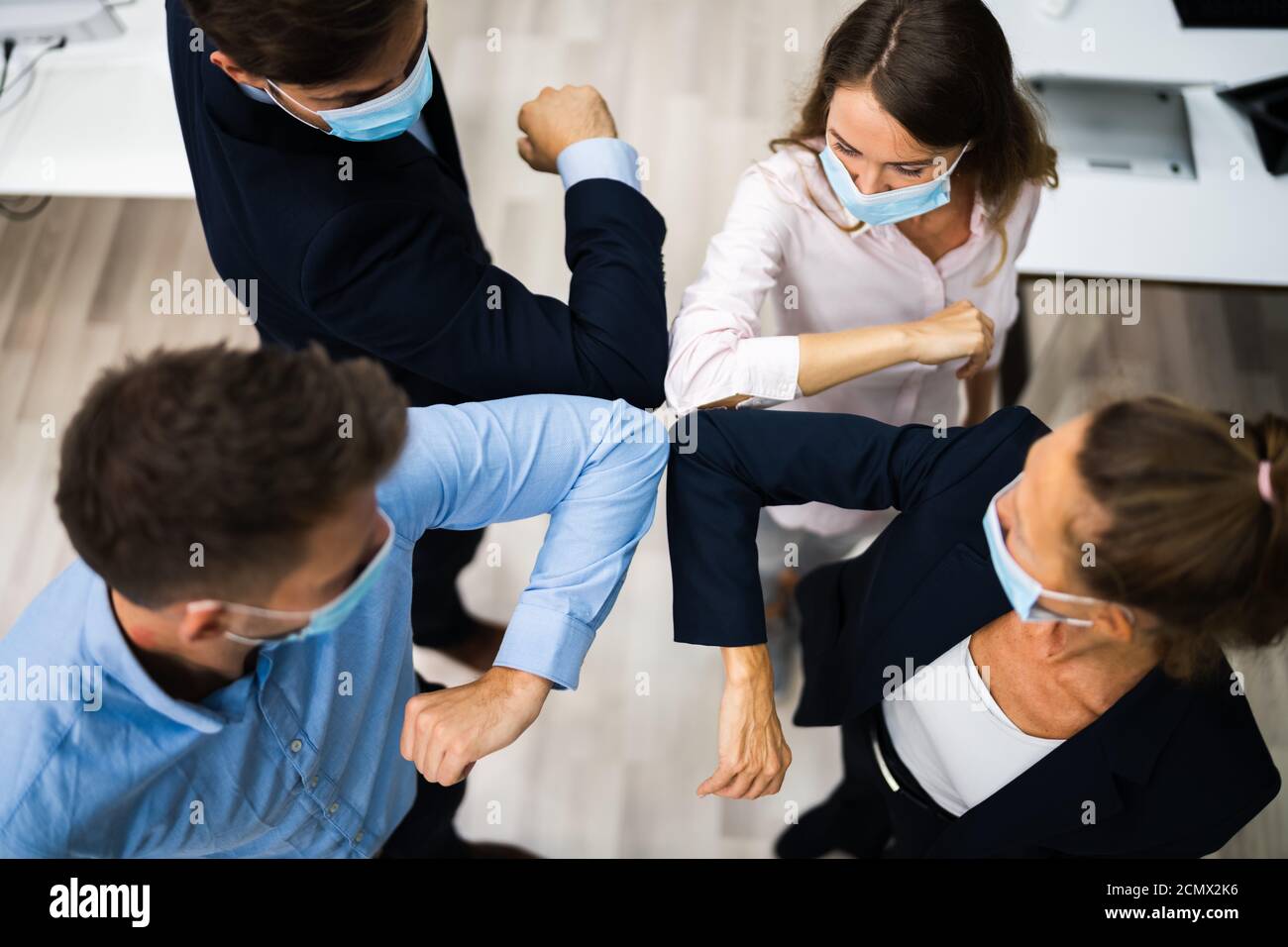 Employees Doing Elbow Bump To Avoid Flu And Stop Covid Spread Stock Photo