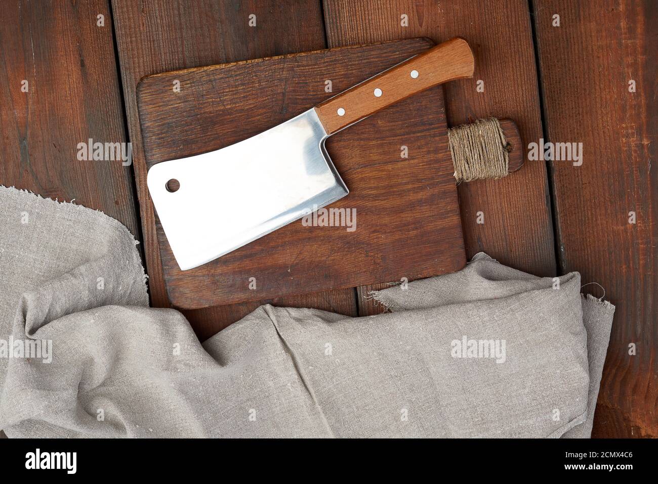 Chef cuts up meat on a cutting board with a sharp knife Stock Photo by  wirestock