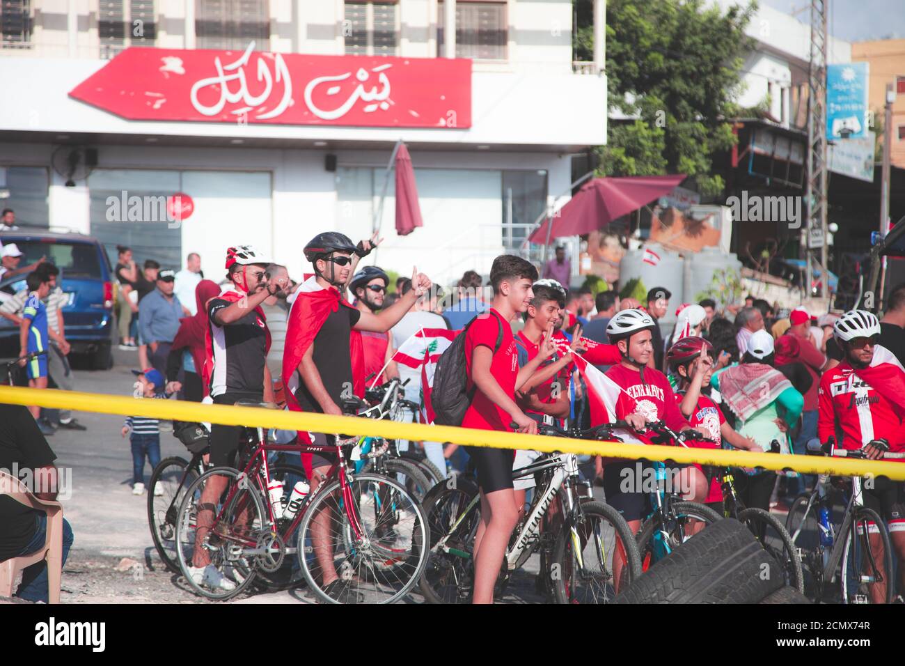 Nabatieh, South / Lebanon: Lebanese Protesters |  a group of young on bicycles with Lebanon Flags Stock Photo