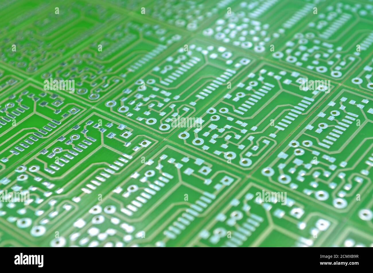 Close-up view of a green electronic circuit boards as a background, selective focus. Concept for development of electronic circuits Stock Photo