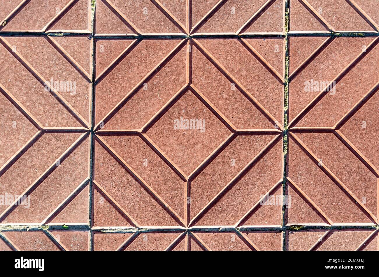 Yellow square-shaped pavement tiles.Beautiful quality texture closeup.Symmetrical pattern. Stock Photo