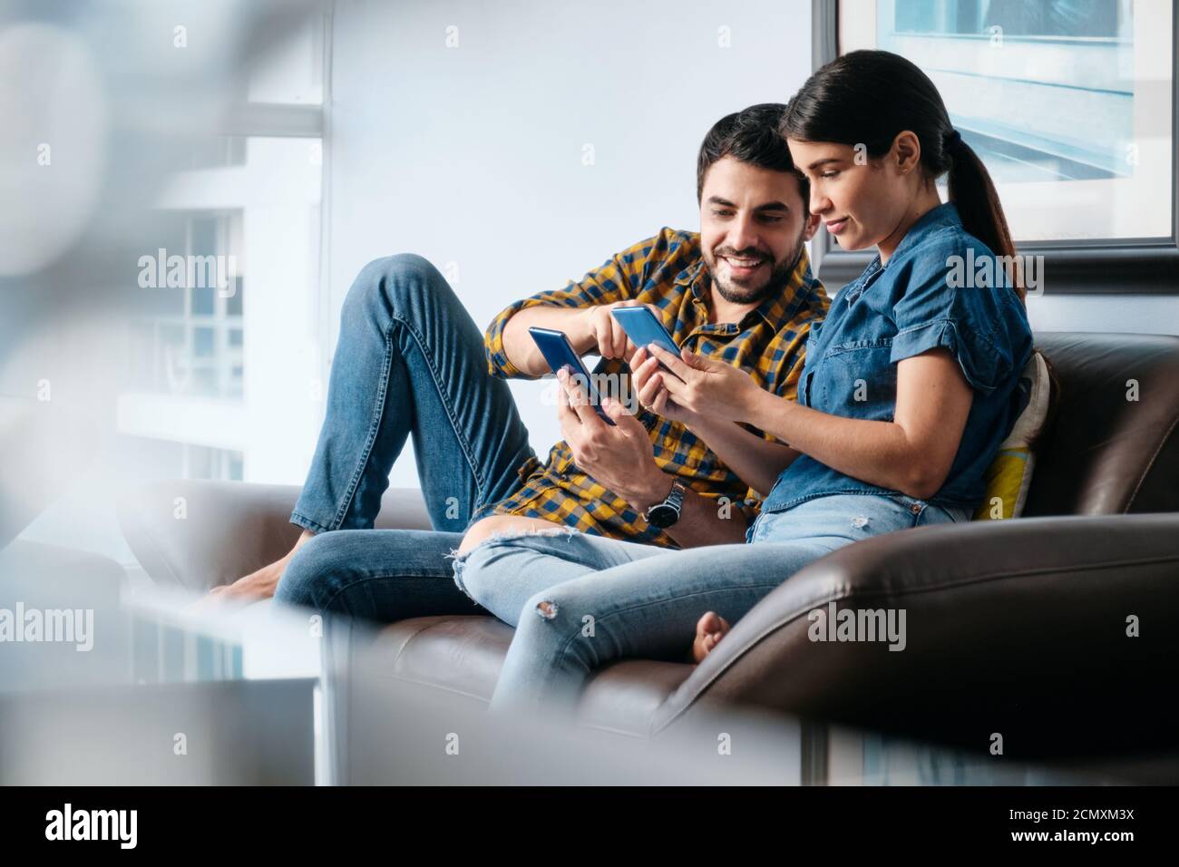 Man Teaching Phone App Technology To Girlfriend With Smartphone Stock Photo