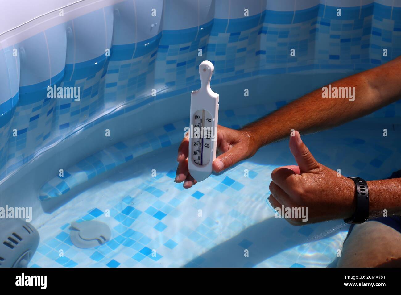 https://c8.alamy.com/comp/2CMXY81/person-measuring-a-temperature-of-the-pool-with-a-thermometer-2CMXY81.jpg