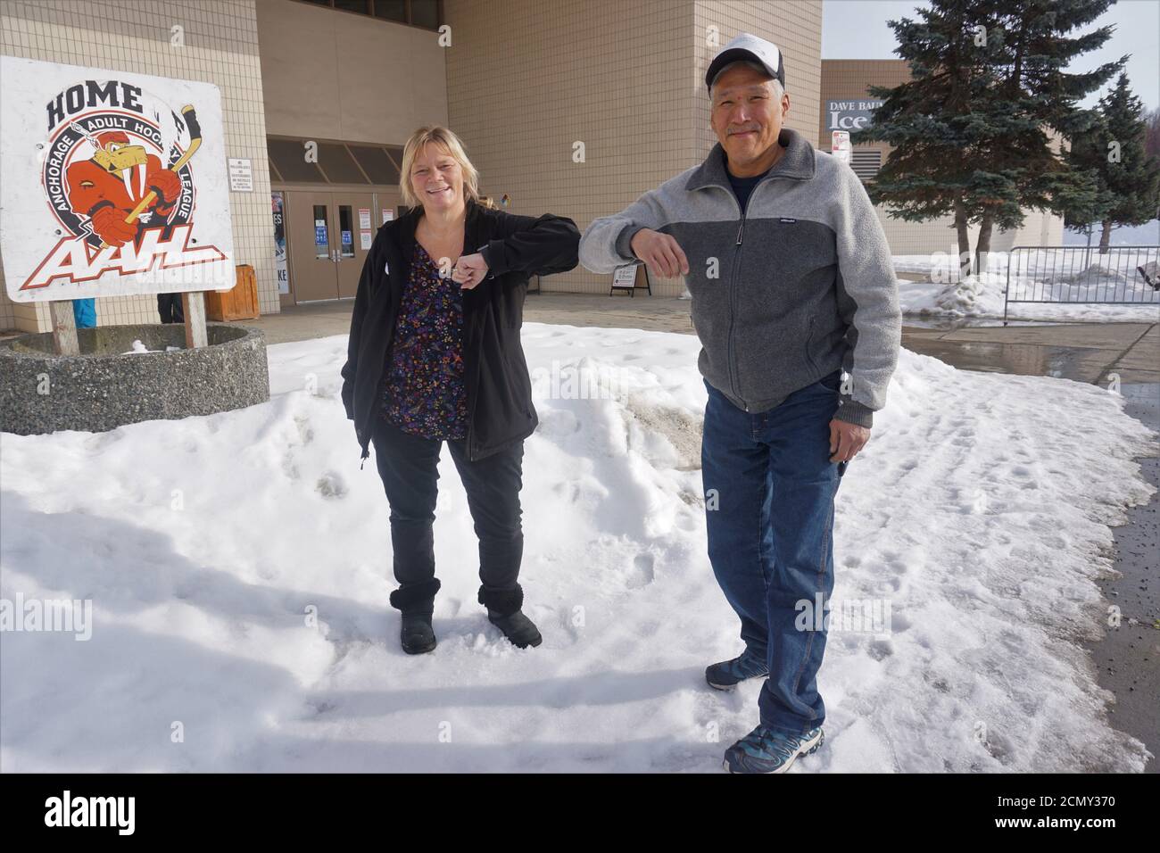 Lisa Sauder Executive Director Of Bean S Cafe And Volunteer Stan Gooden Childers Do An Elbow Bump Outside The Entrance To The Ben Boeke Ice Arena In Anchorage Alaska U S March 23 Ben