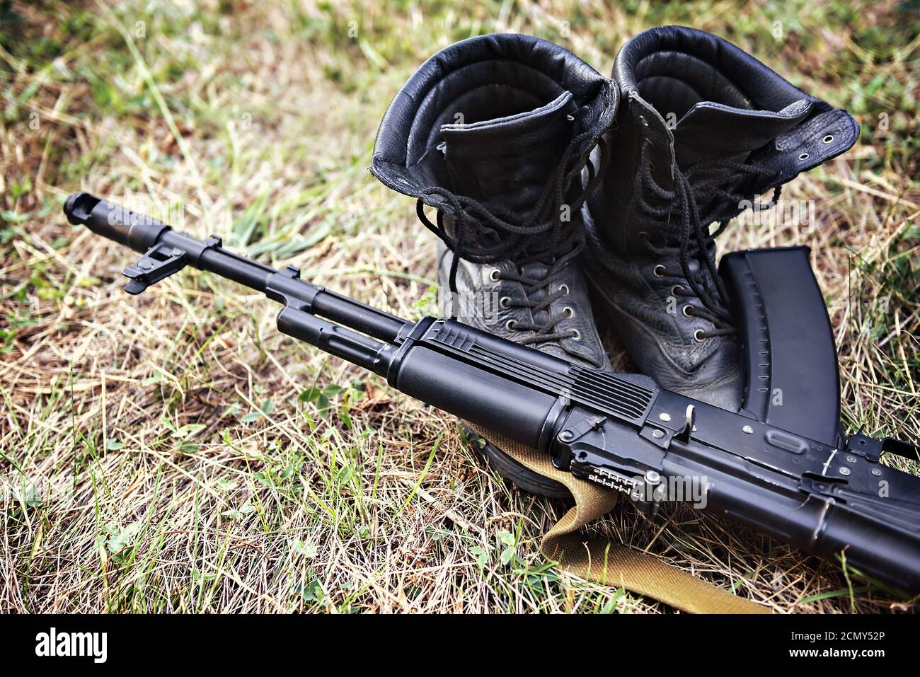 soldier ankle boots and a Kalashnikov assault rifle close-up Stock Photo
