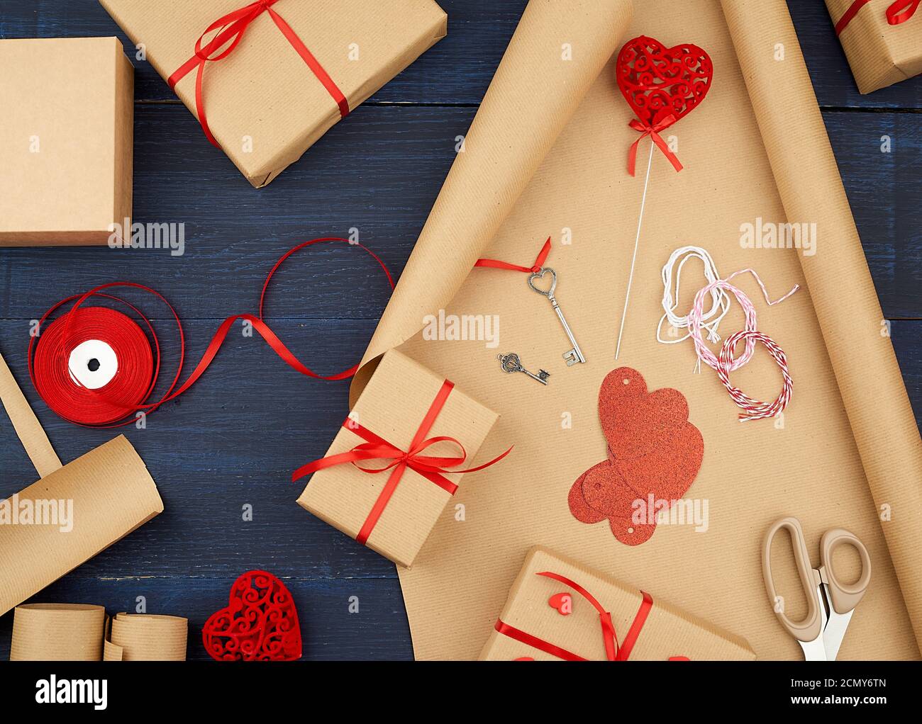 brown kraft paper, packed gift bags and tied with a red ribbon, red heart, set of items for making g Stock Photo