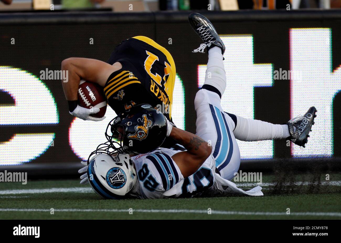 Hamilton Tiger-Cats Luke Tasker is tackled by Toronto Argonauts Joe Rankin  (R) during the first half of their CFL game in Hamilton, September 5, 2016.  REUTERS/Mark Blinch Stock Photo - Alamy