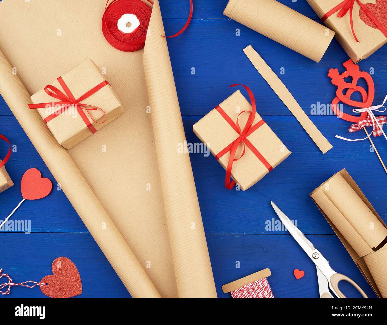 brown kraft paper, packed gift bags and tied with a red ribbon, red heart, set of items for making g Stock Photo