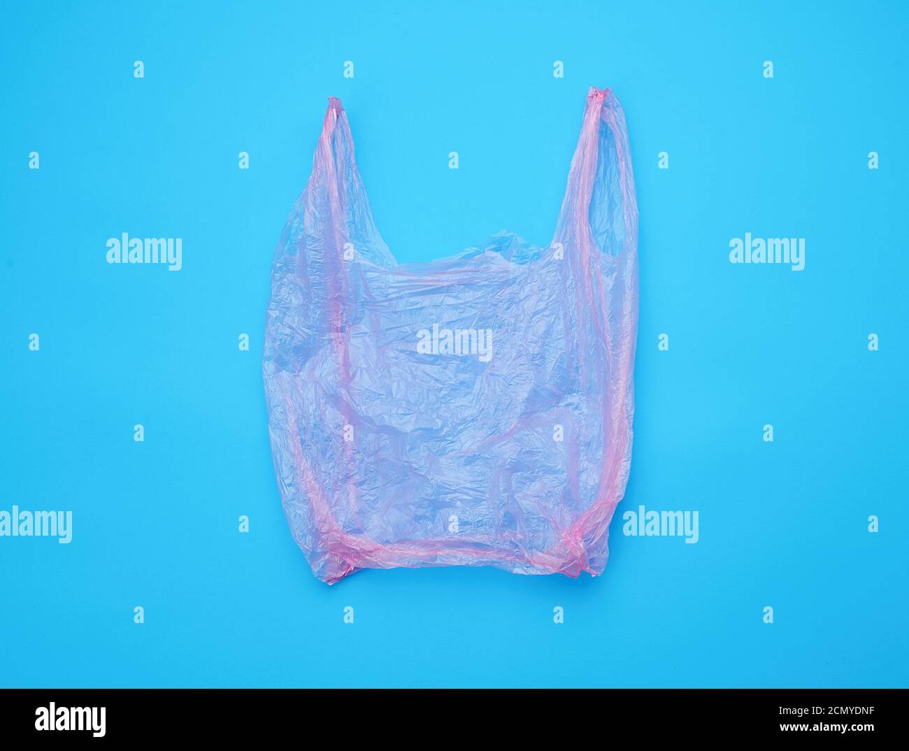 open empty plastic pink bag for products on a blue background Stock Photo