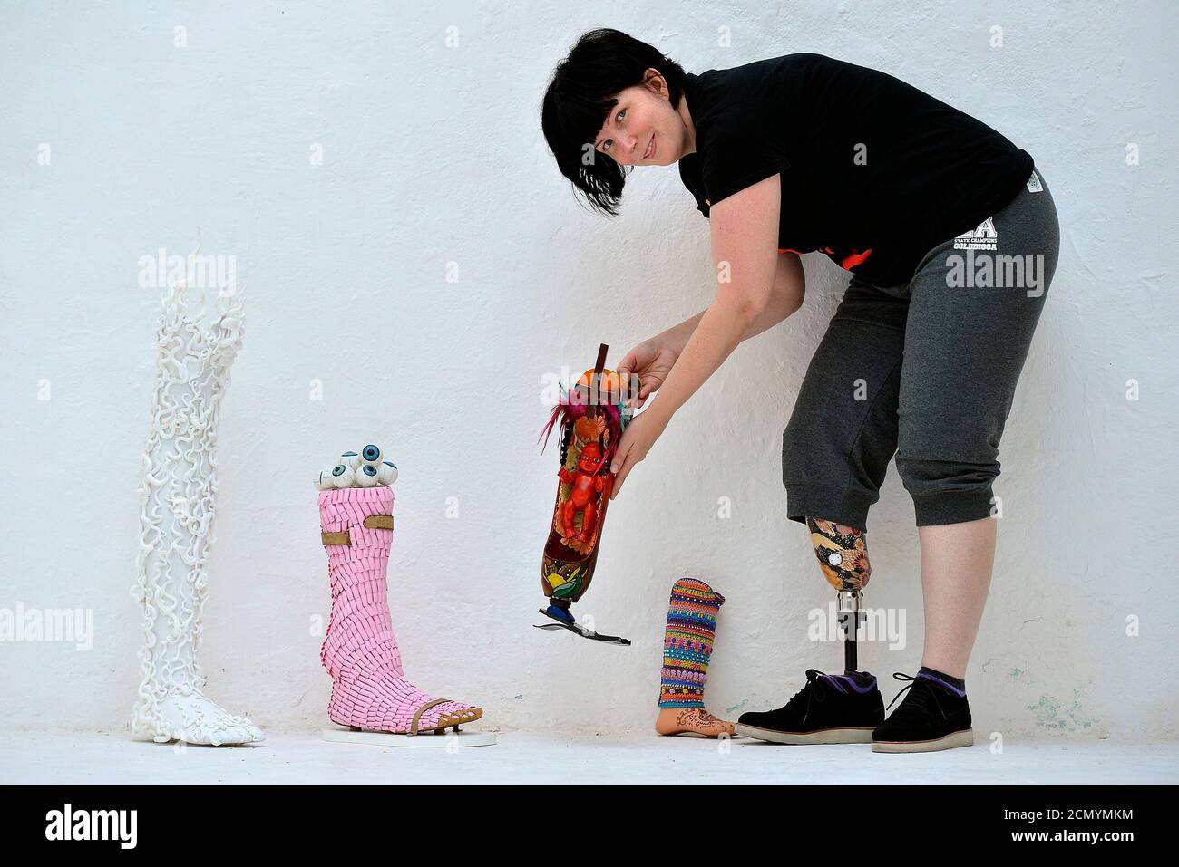 Australian artist and curator Priscilla Sutton arranges pieces for her show 'Spare Parts' at The Rag Factory in London August 24, 2012. The exhibition comprises of prosthetic limbs  - donated by owners no longer using them - and then transformed into pieces of art, and is being held to coincide with the London 2012 Paralympics. REUTERS/Toby Melville (BRITAIN - Tags: ENTERTAINMENT HEALTH SPORT OLYMPICS) Stock Photo
