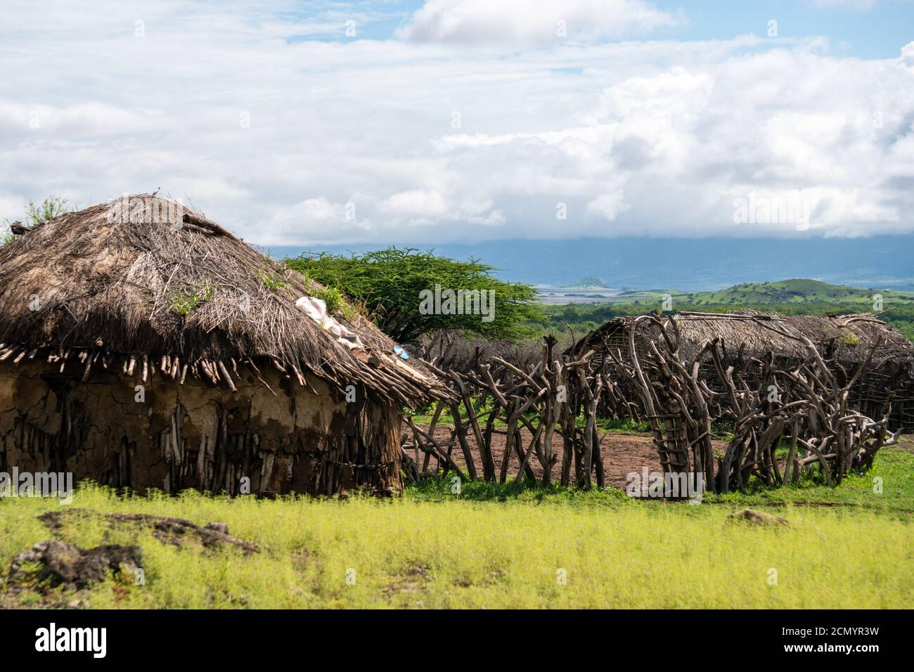 Traditional Maasai Village with Clay Round Huts in Engare Sero area near Lake Natron and Ol Doinyo Lengai volcano in Tanzania, Africa Stock Photo