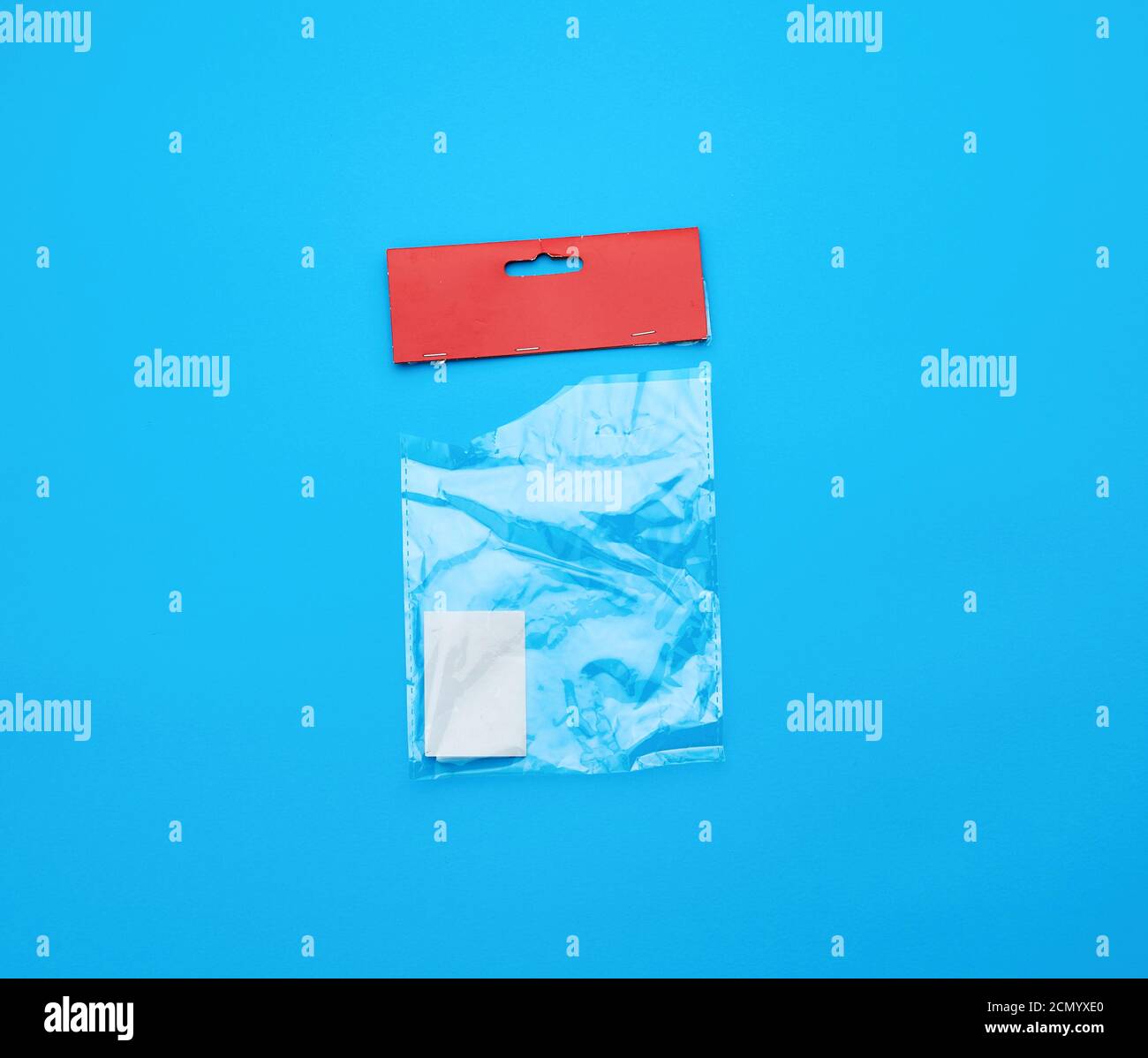 transparent torn plastic bag with paper red top for packaging goods