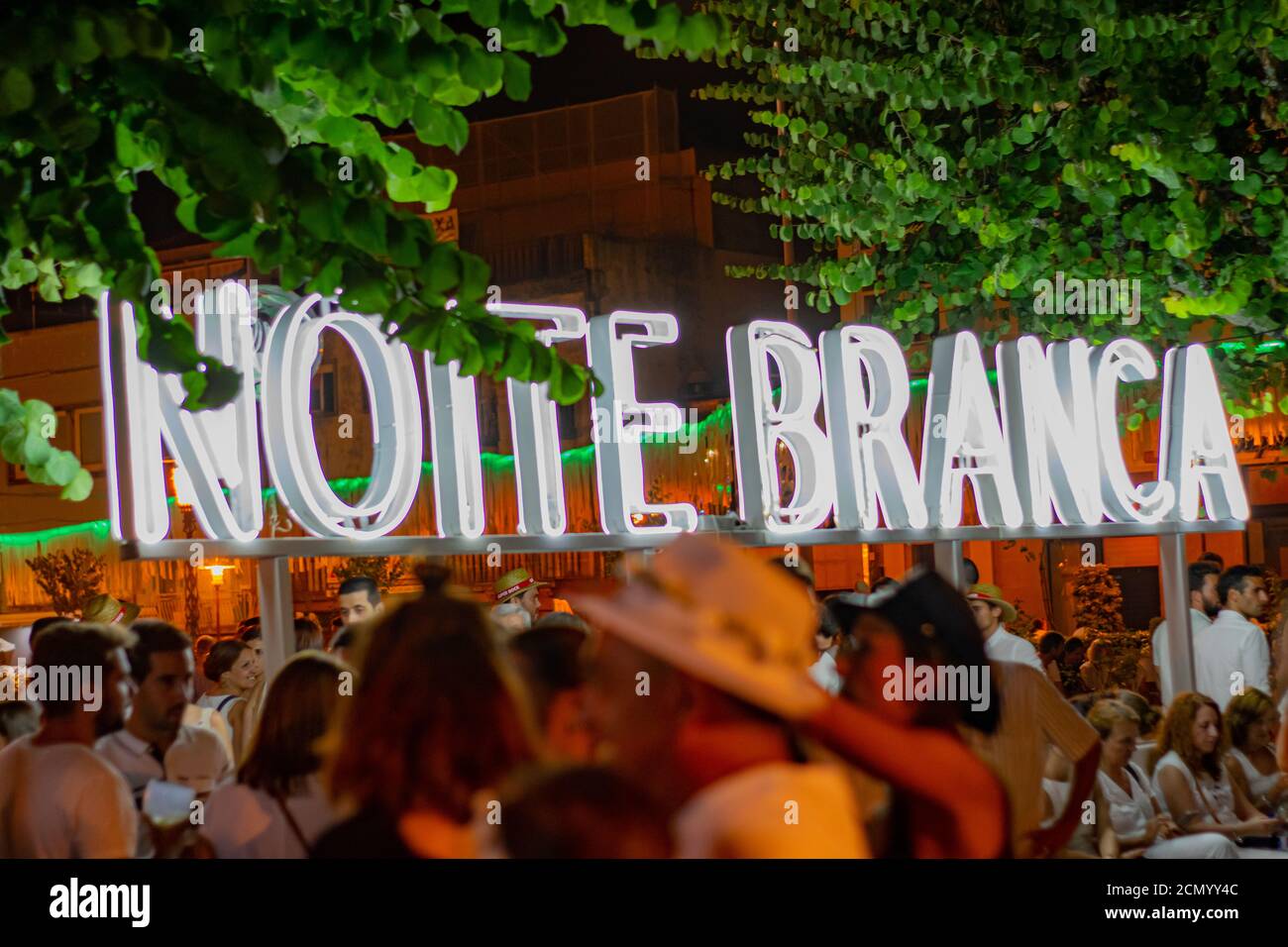 Noite Branca lighting sign event in city of Braga Portugal before covid19.  People reuniting om city social events Stock Photo - Alamy