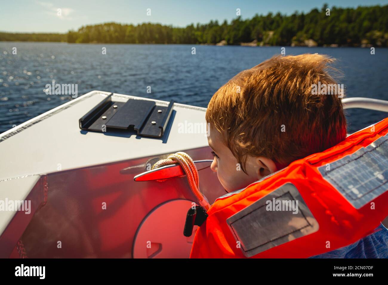 Boy riding in the bow of a boat on Lake Kabetogama in Voyageurs National Park, Minnesota Stock Photo
