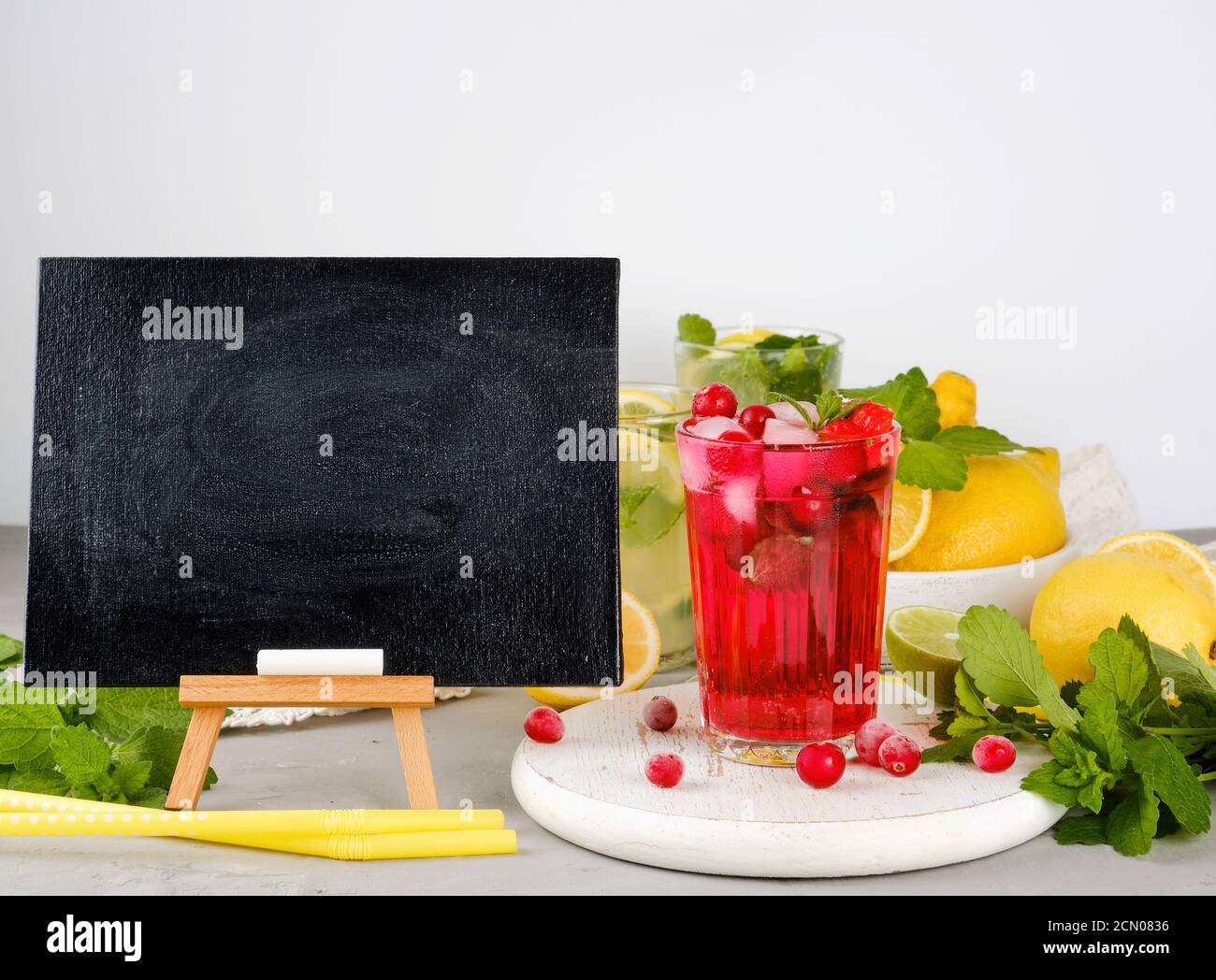empty black chalk board for writing a summer drink recipe and a glass with berry lemonade Stock Photo