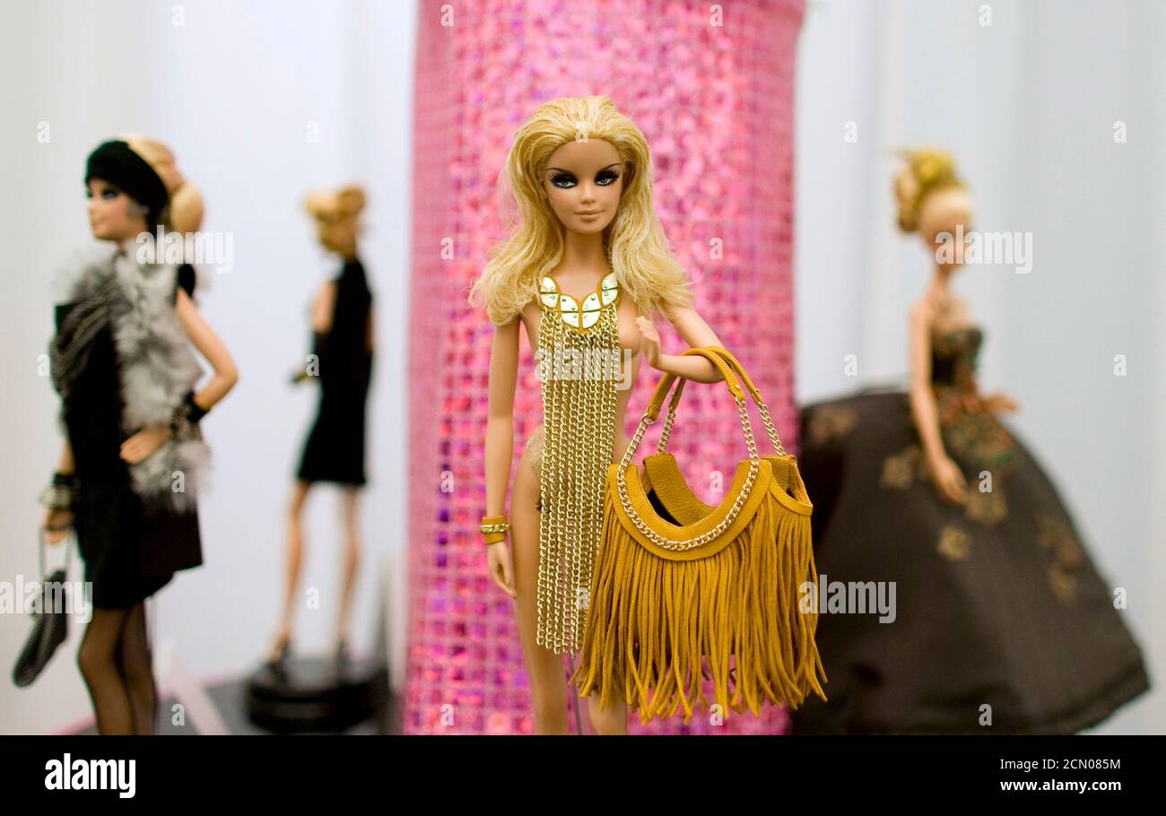A Barbie doll in a dress and with accessories by German designer Kaviar  Gauche (C) is seen at an exhibition in the Galeries Lafayette department  store in Berlin June 25, 2009. Marking