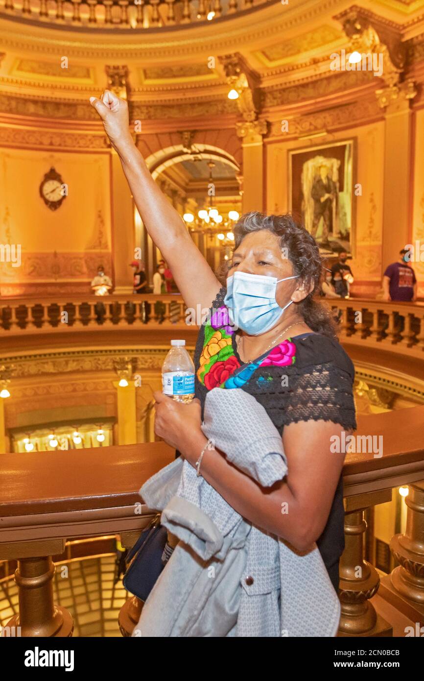 Lansing, Michigan - Activists rally in the Michigan State Capitol building, demanding that the legislature allow undocumented immigrants to get driver Stock Photo