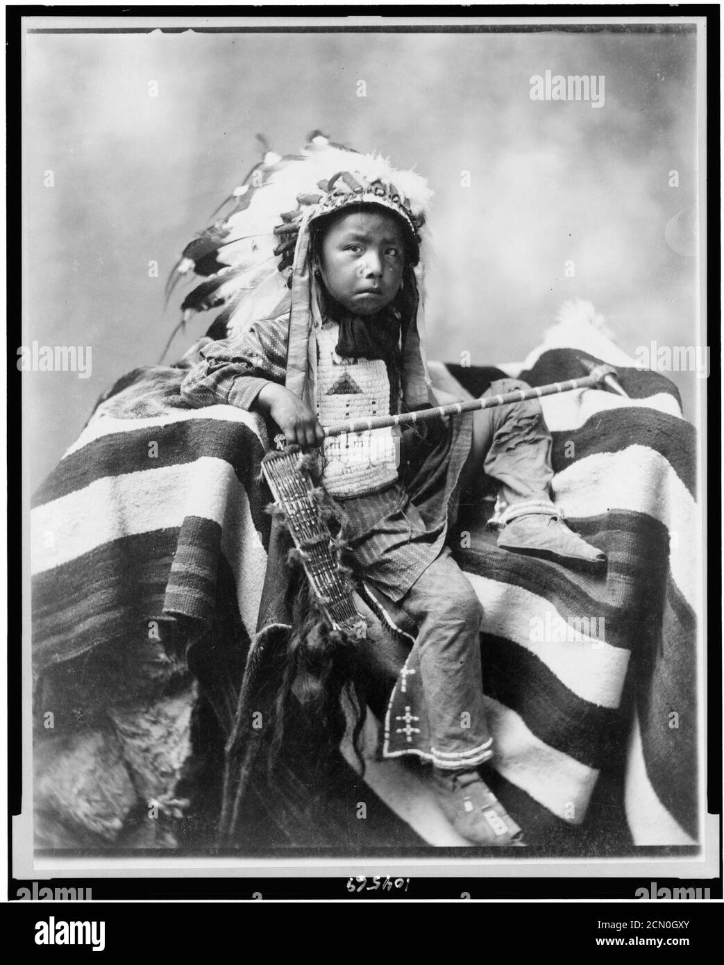 Joseph Bird Head, Lakota or Sioux, full-length portrait, seated on blanket holding handcrafted club, facing slightly right Stock Photo