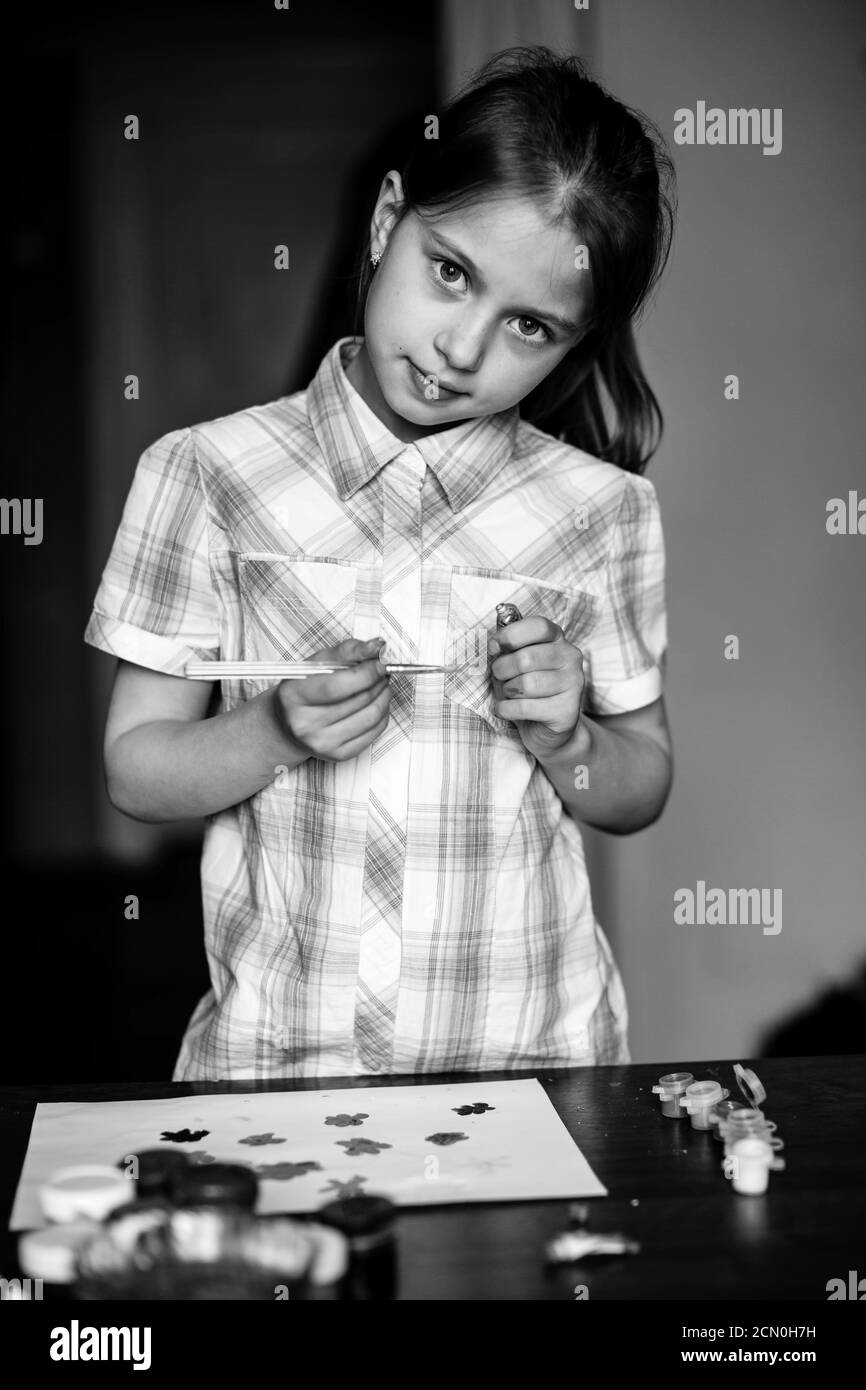 Little girl during a painting. Black and white photography. Stock Photo