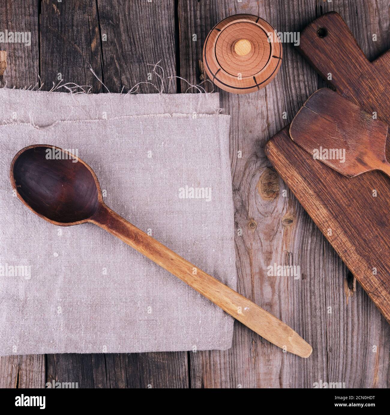 very old empty wooden spoon and rectangular cutting board Stock Photo