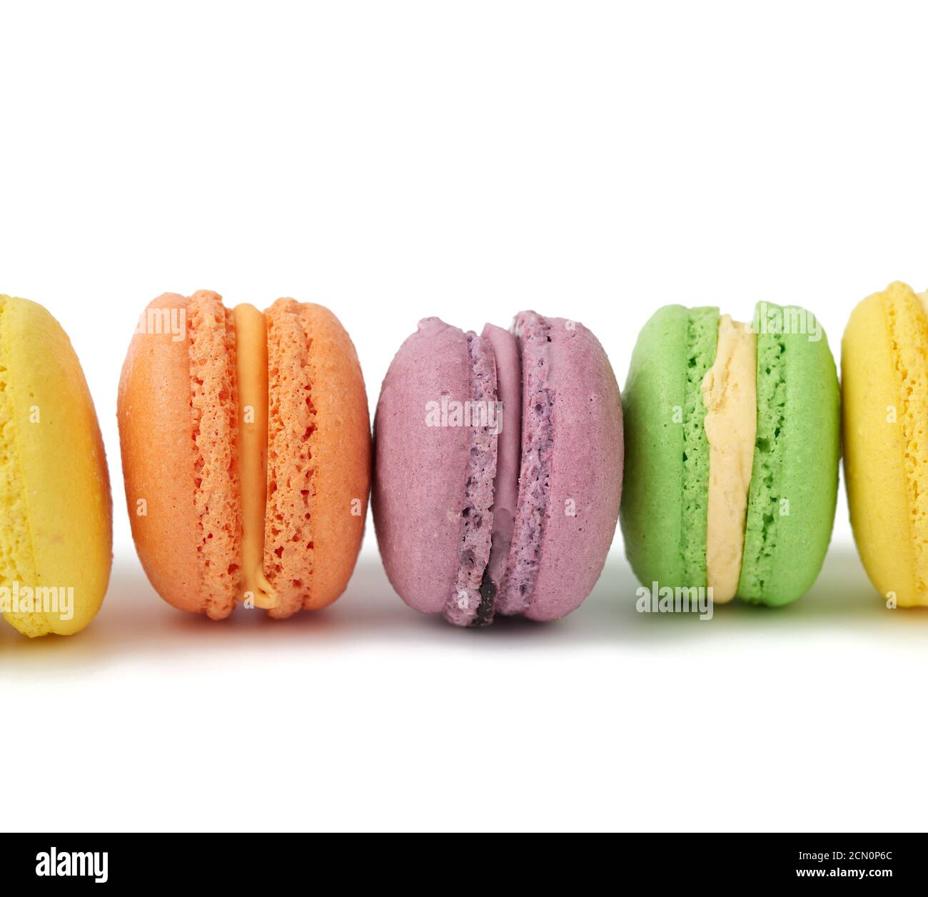 multi-colored round baked macarons cakes on a white isolated background Stock Photo