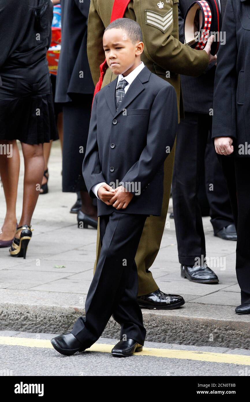 Kevin, son of Lance Sergeant Dale McCallum of 1st Battalion Scots Guards, waits after his father's funeral service at the New Testament Church of God in Willesden, London August 20, 2010. McCallum was killed in the conflict in Afghanistan on August 1.    REUTERS/Stefan Wermuth (BRITAIN - Tags: MILITARY CONFLICT) Stock Photo