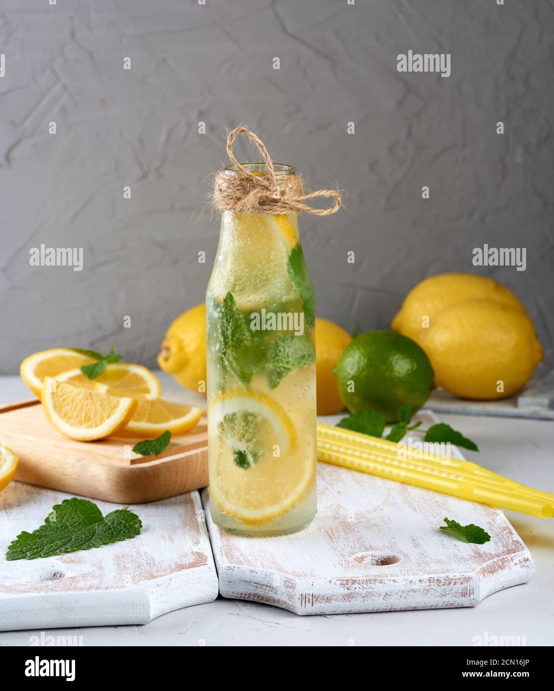 summer refreshing drink lemonade with lemons, mint leaves, lime in a glass bottle Stock Photo