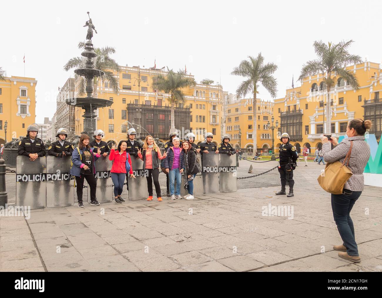 Asian tourists pose with police in Lima, Peru Stock Photo