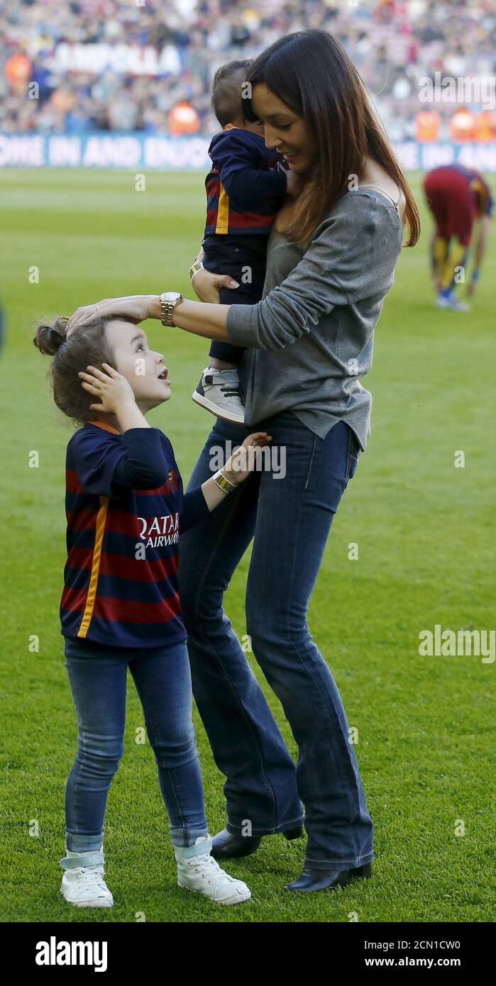 Barcelona's soccer player Andres Iniesta's wife Anna Ortiz is seen with her  daughter Valeria as she holds her son Paolo Andrea (R) before the Spanish  first division soccer match against Villarreal at