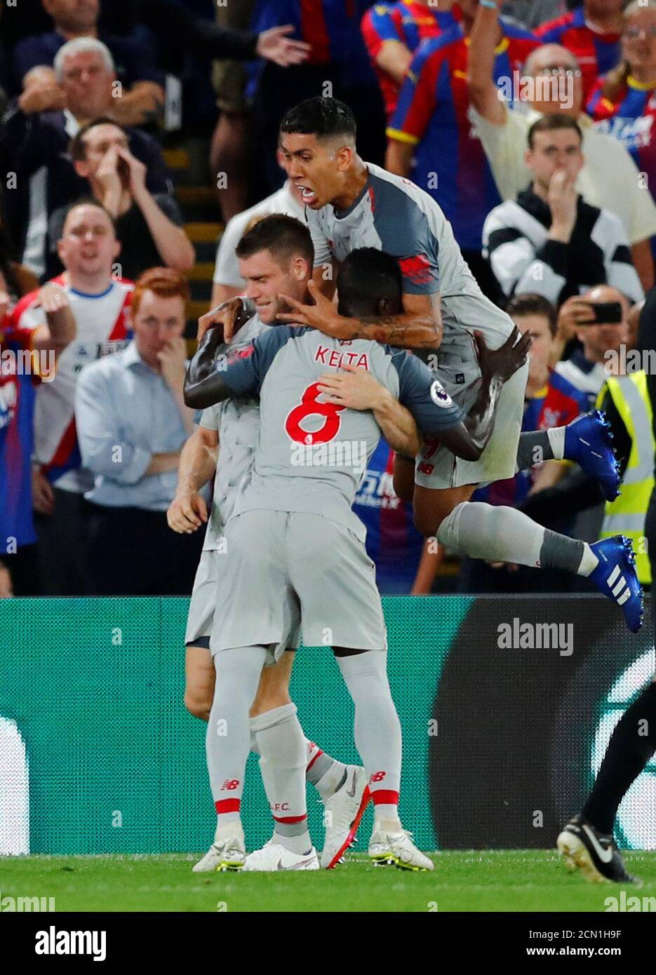 Soccer Football - Premier League - Crystal Palace v Liverpool - Selhurst Park, London, Britain - August 20, 2018 Liverpool's James Milner celebrates scoring their first goal from the penalty spot with Naby Keita and Roberto Firmino REUTERS/Eddie Keogh EDITORIAL USE ONLY. No use with unauthorized audio, video, data, fixture lists, club/league logos or "live" services. Online in-match use limited to 75 images, no video emulation. No use in betting, games or single club/league/player publications. Please contact your account representative for further details. Stock Photo