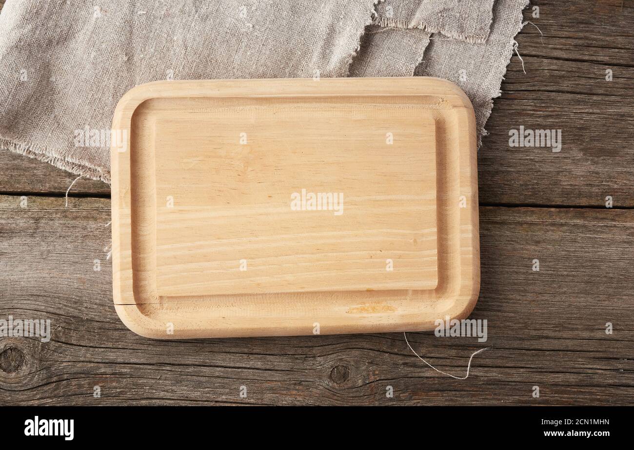 light beige rectangular empty cutting kitchen board on a wooden background from old boards Stock Photo