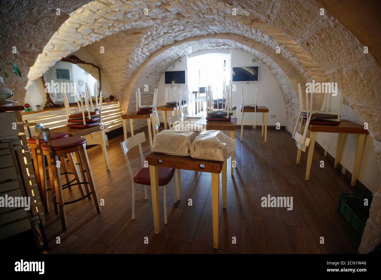 An empty  '20mq Panini e Poi' restaurant is pictured in the small southern historical town of Cisternino, Italy, April 4, 2020. Picture taken April 4, 2020. Perrini family have dealt with Italy's strict lockdown measures to combat the spread of the coronavirus disease (COVID-19) with two young daughters studying at home, and owning three restaurants and a bar that can't fully open until June 1. REUTERS/Alessandro Garofalo Stock Photo