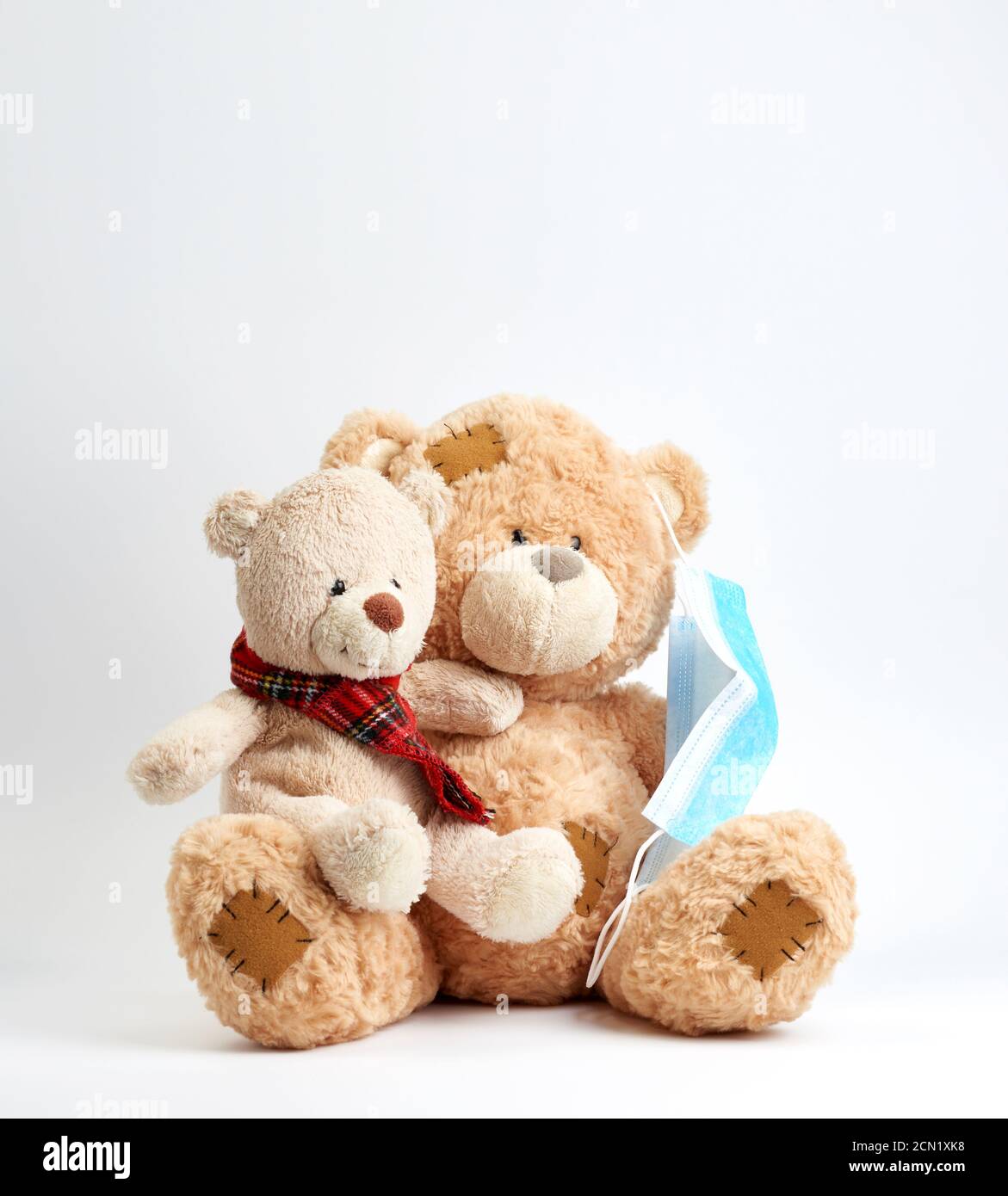 big teddy bear are sitting in blue medical masks on a blue background