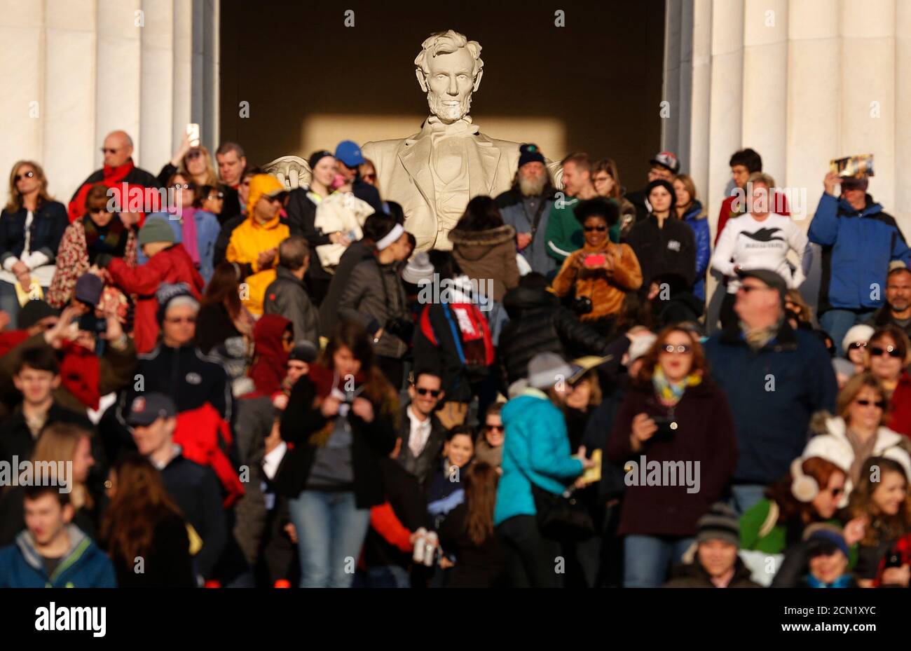 Crowds stand on the steps  at the Lincoln Memorial in Washington during an Easter morning sunrise religious service April 5, 2015. On April 15 the United States commemorates the 150th anniversary of President Abraham Lincoln's assassination. Events will include the re-enactment of his funeral in Springfield, Illinois, as well as talks and plays at Ford's Theatre in Washington D.C., where Confederate sympathiser John Wilkes Booth shot him in 1865. Lincoln, who kept the Union together in the American Civil War and helped secure the end of slavery, has enduring appeal both in the United States an Stock Photo