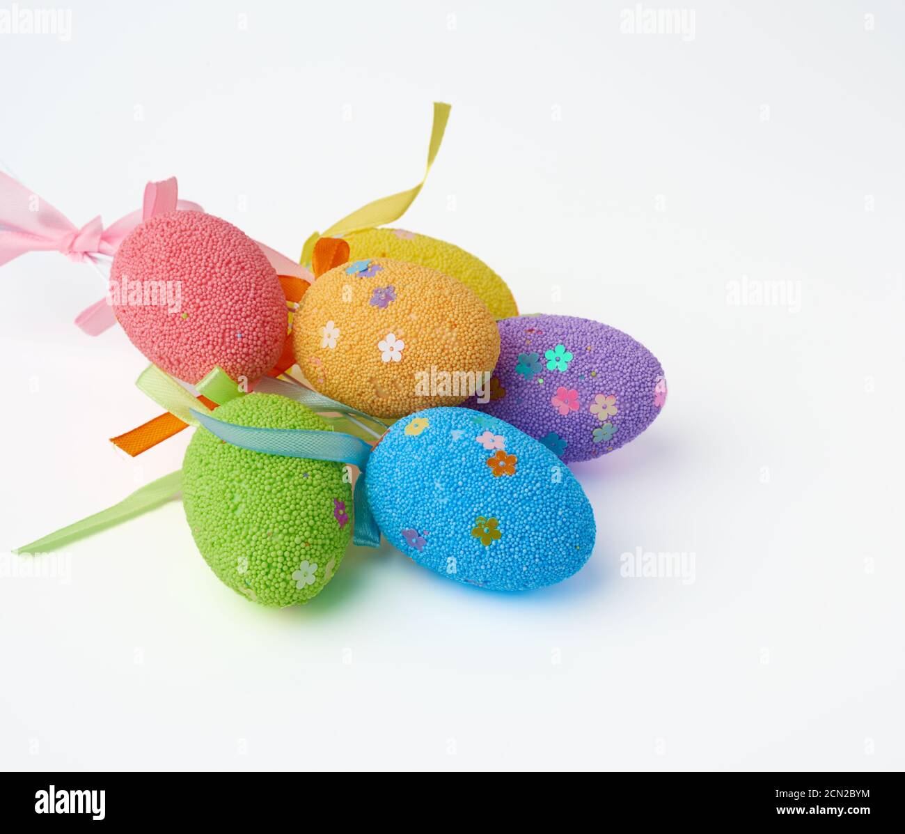 multi-colored decorative Easter eggs on sticks on a white background Stock Photo