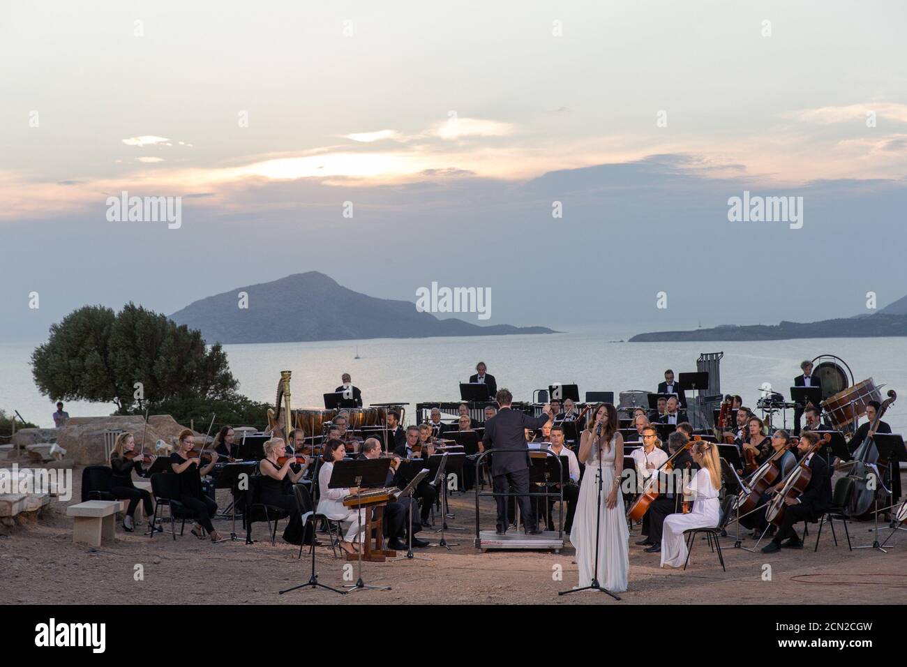 (200917) -- ATHENS, Sept. 17, 2020 (Xinhua) -- Musicians perform a musical in front of the ruins of the Temple of Poseidon at cape Sounion, some 70 km southeast of Athens, Greece, on Sept. 17, 2020. On the occasion of the 70th anniversary of the establishment of the Greek National Tourism Organization (GNTO) and the 71st anniversary of the founding of the People's Republic of China and the Mid-Autumn festival, a musical entitled 'As long as there shall be Achaeans -- Variations on a Sunbeam' was staged on Thursday in front of the ruins of the emblematic 2,500-year-old Temple of Poseidon, the g Stock Photo