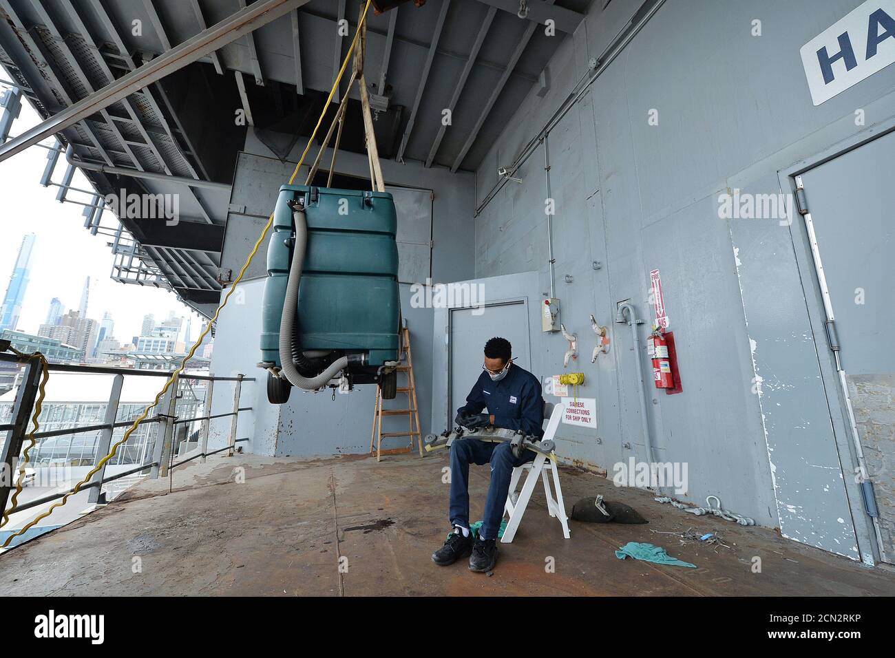 Intrepid Maintenance crew member Jason Gallant works on repairing a floor scrubber on the lower deck of the Intrepid Sea, Air & Space Museum scheduled to reopen (September 25) to the public, in New York, NY, September 17, 2020. More than 200 hand sanitizer dispensers will be set up throughout the exhibits, tickets will be time reserved, one way foot-traffic signs will help visitors navigate the exhibitions which will be cleaned and disinfected every hour; access to the Concord, submarine and food services will remain closed. (Anthony Behar/Sipa USA) Stock Photo