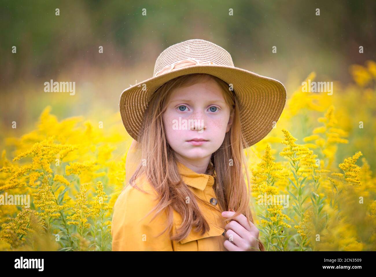 Young Girl in Yellow Dress in a Field of Flowers Stock Photo - Alamy