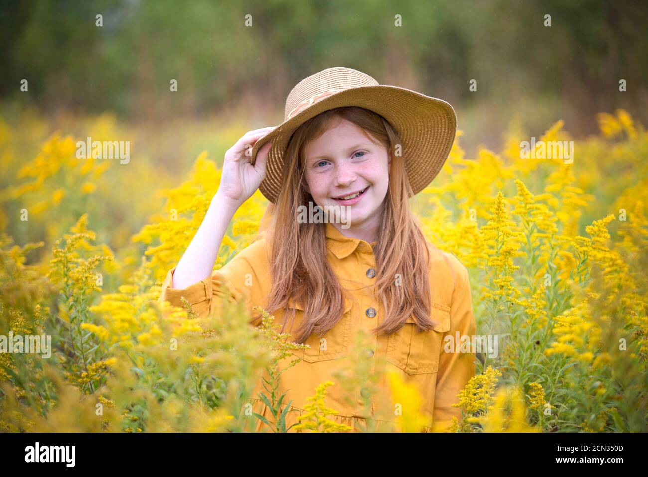 Young Girl in Yellow Dress in a Field of Flowers Stock Photo - Alamy