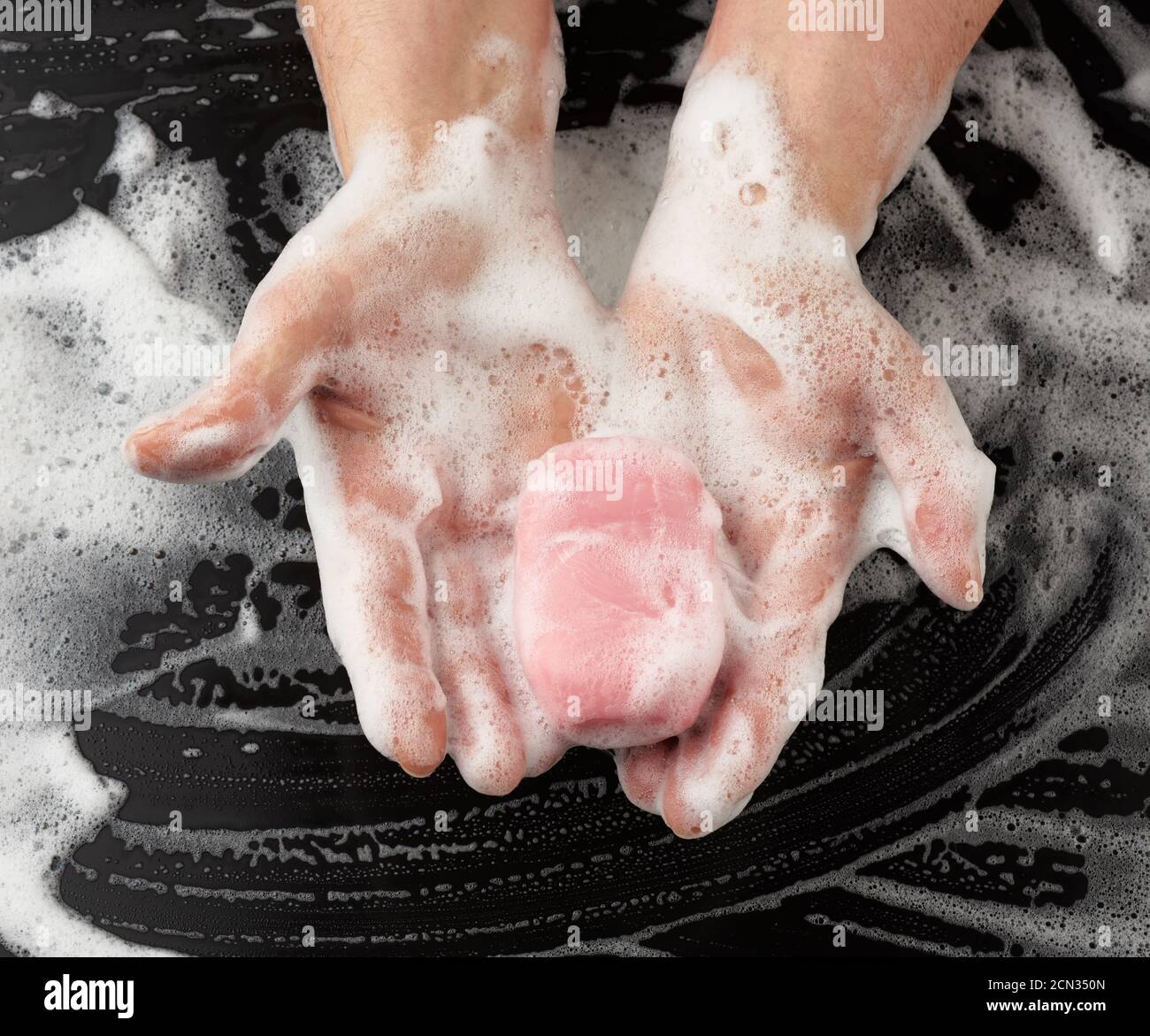process of washing hands with pink soap, parts of the body in white foam Stock Photo Alamy