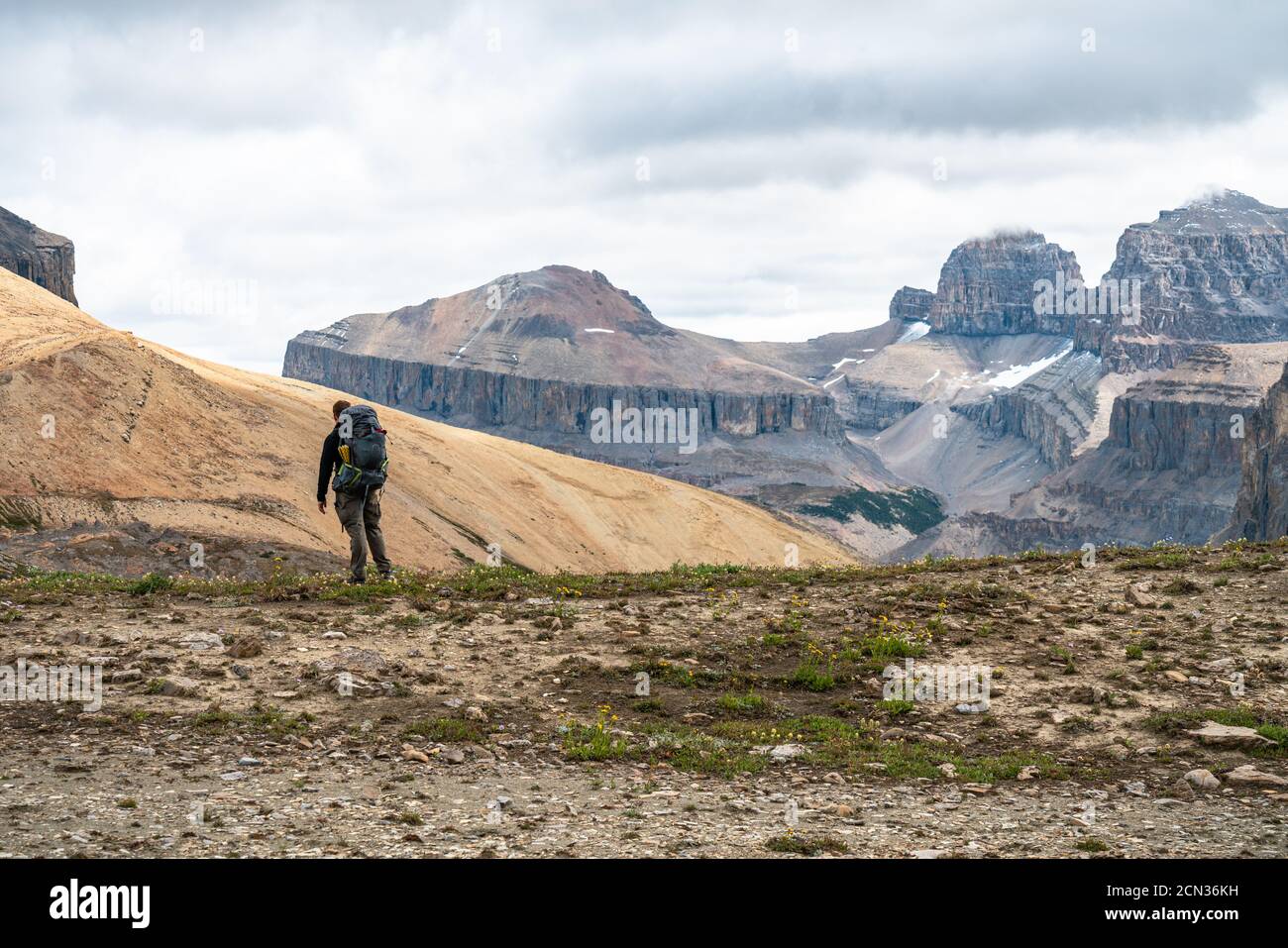 Hiker Observing Remote Mountain Peaks in Distance Stock Photo