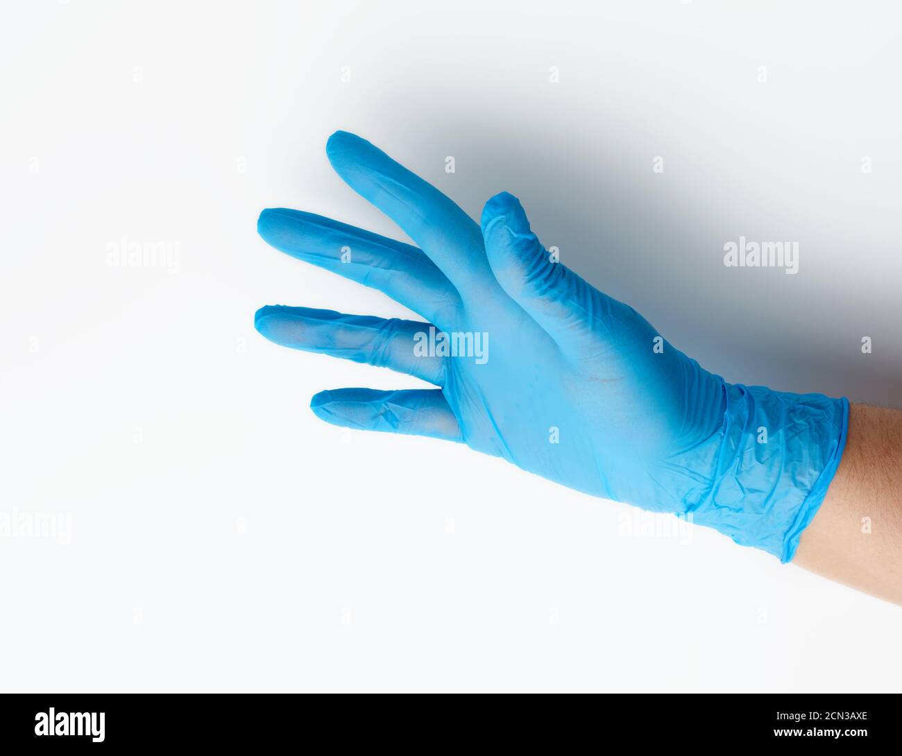blue medical glove is worn on the arm, part of the body on a white