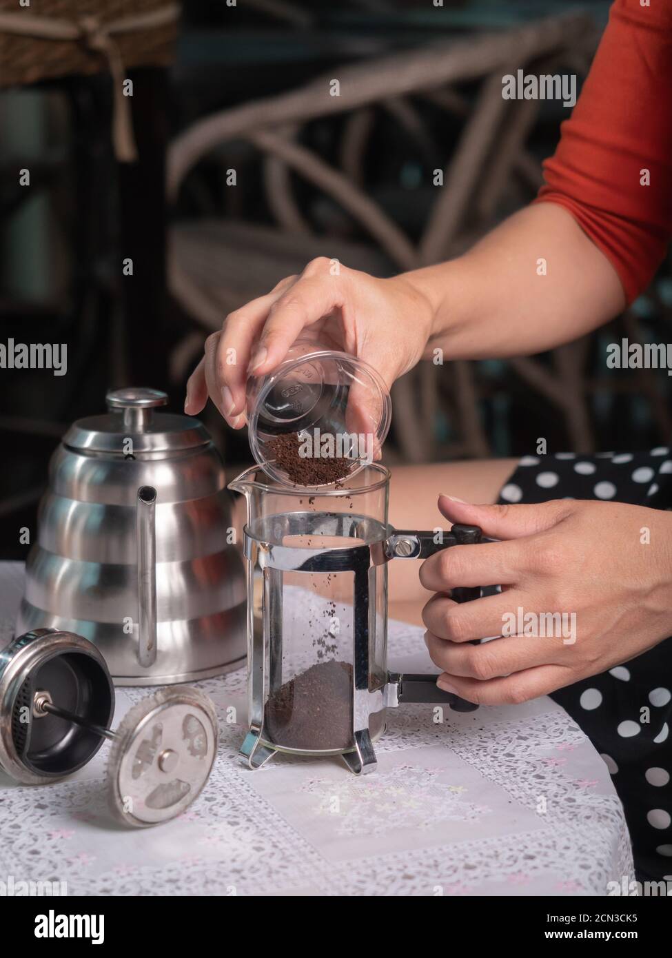 putting ground coffee into french press mug Stock Photo Alamy