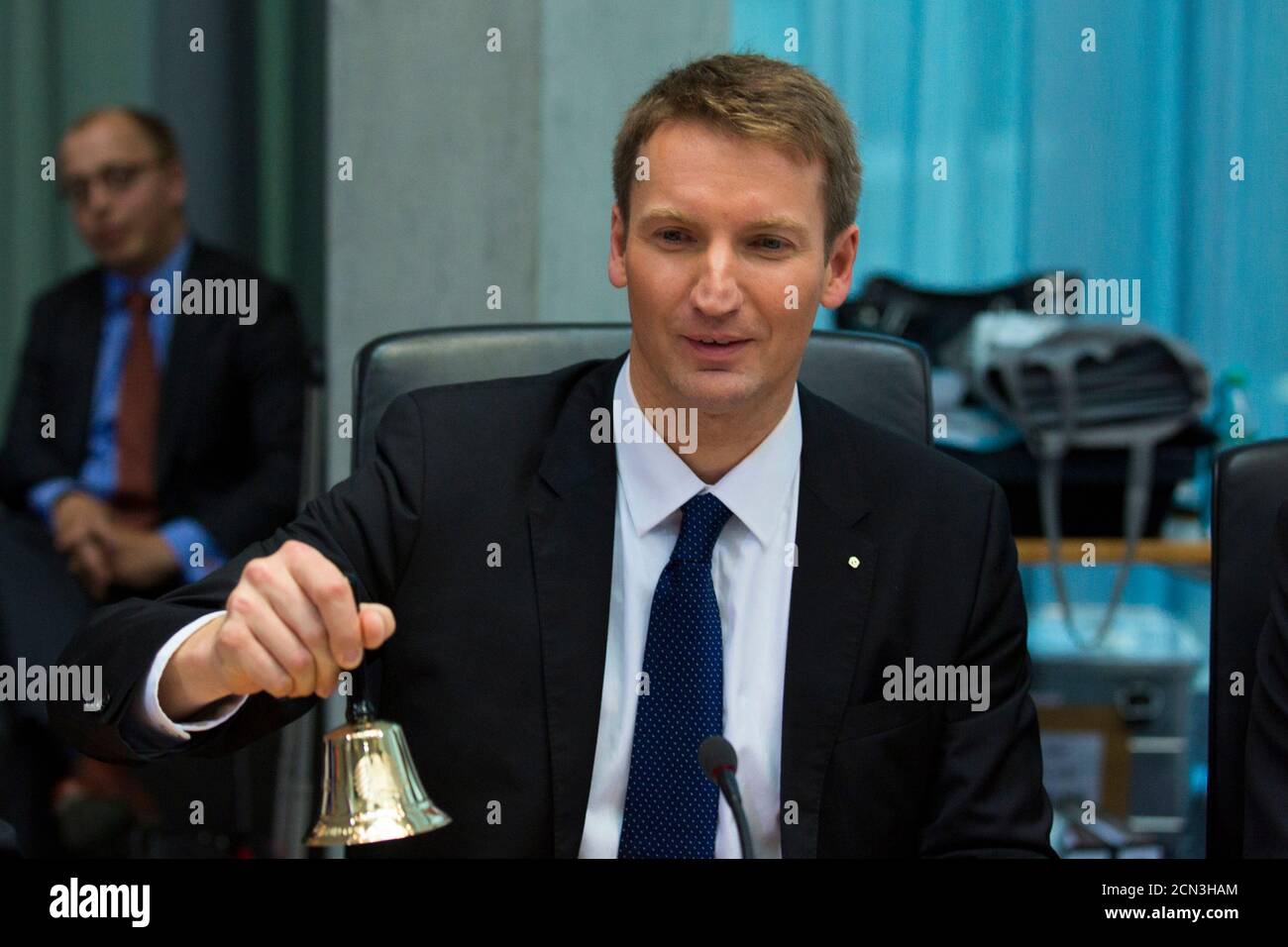 Inquiry commission head Patrick Sensburg rings a bell to start a hearing of a parliamentary inquiry into the NSA's activities in Germany, in Berlin July 3, 2014.  REUTERS/Thomas Peter (GERMANY - Tags: POLITICS) Stock Photo