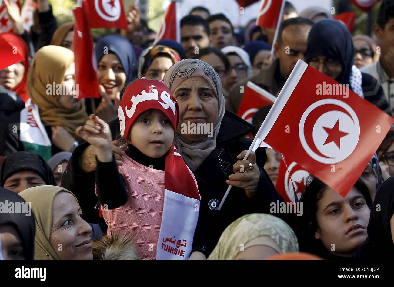 A girl waves a Tunisian flags during celebrations marking the fifth anniversary of Tunisia's 2011 revolution, in Habib Bourguiba Avenue in Tunis, Tunisia January 14, 2016. REUTERS/Zoubeir Souissi Stock Photo